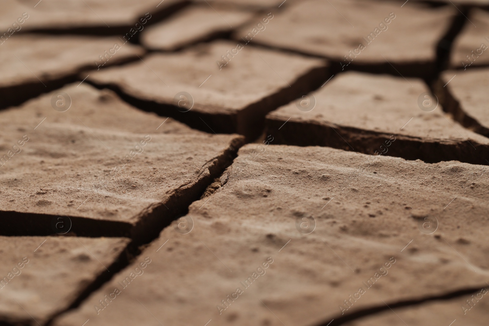 Photo of Dry cracked ground as background, closeup. Global warming