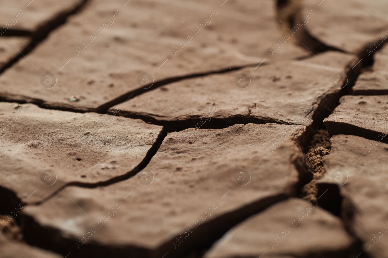 Photo of Dry cracked ground as background, closeup. Global warming