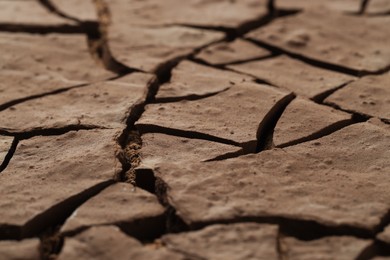 Photo of Dry cracked ground as background, closeup. Global warming