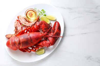 Photo of Delicious boiled lobster served on marble table, top view. Space for text