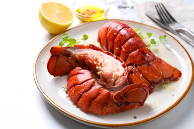 Delicious tails of boiled lobsters served on white table, closeup