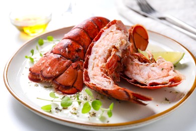 Photo of Delicious tails of boiled lobsters served on white table, closeup