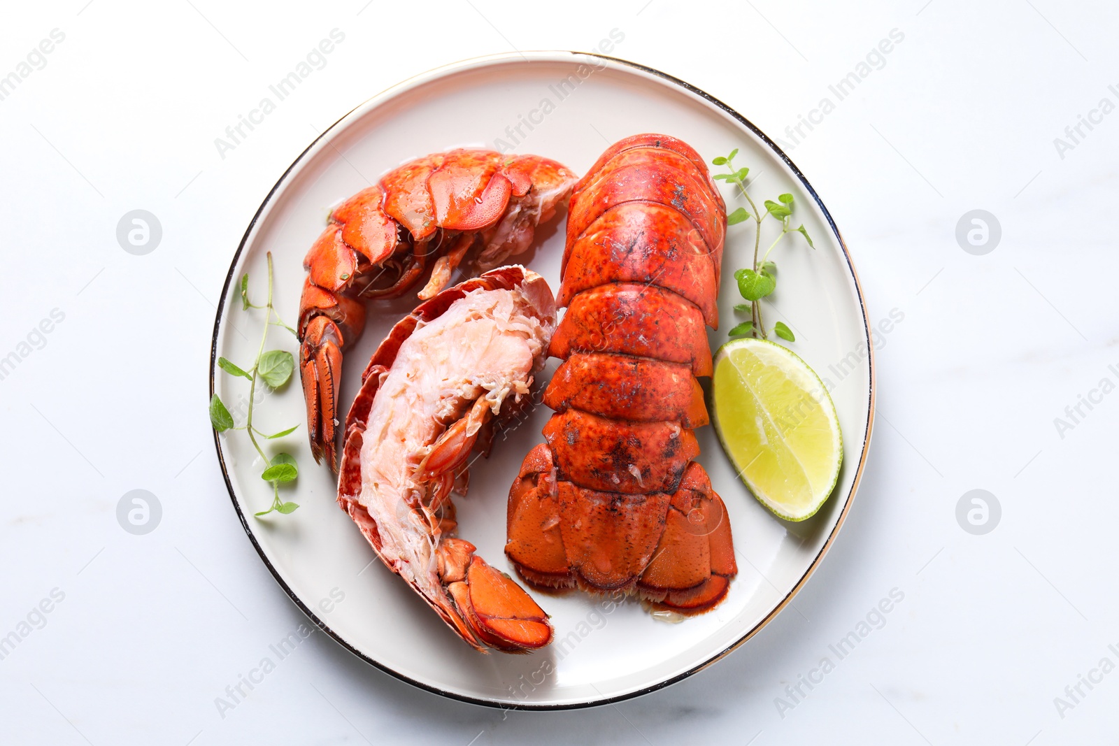 Photo of Delicious tails of boiled lobsters served on white table, top view