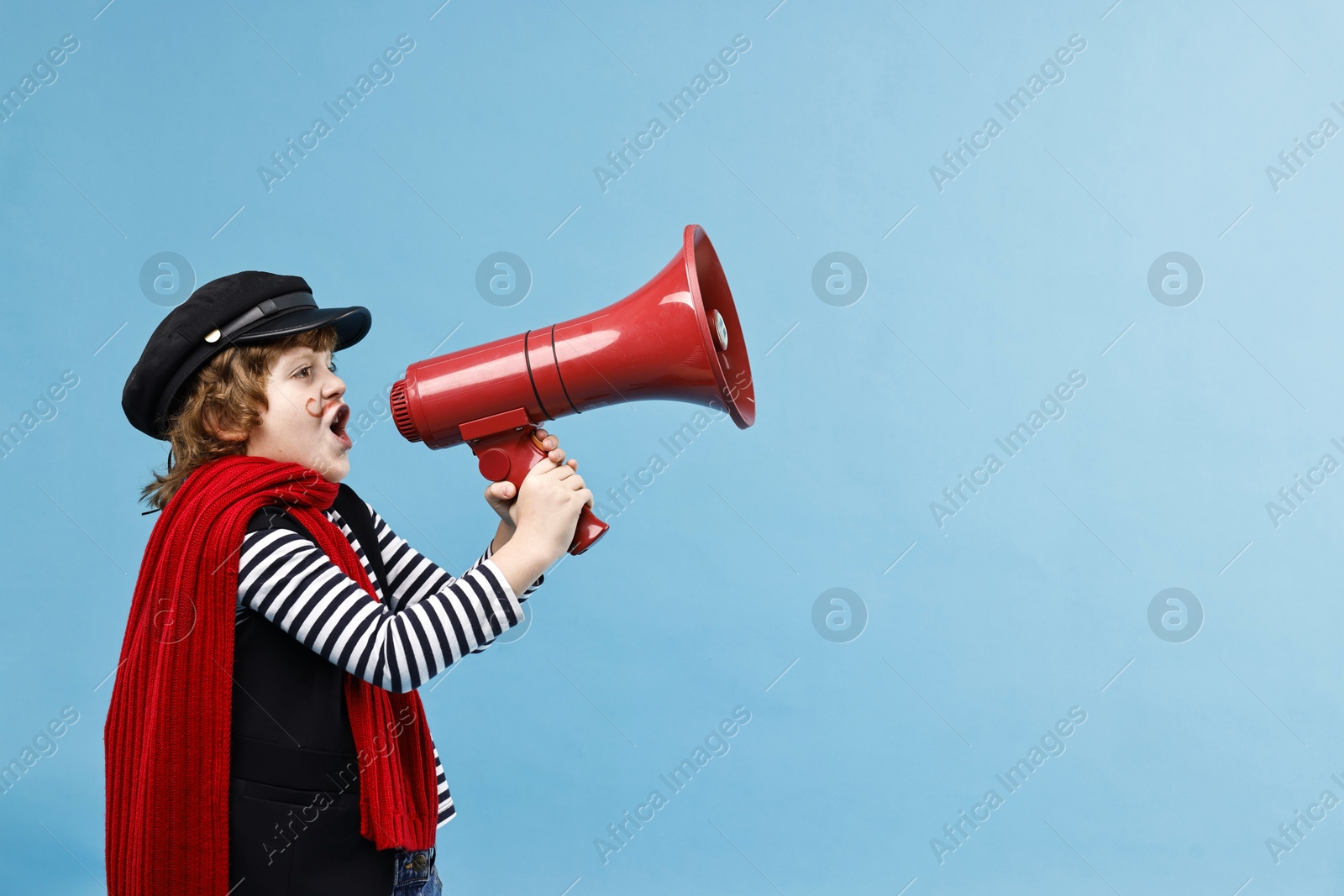 Photo of Cute boy in mime costume shouting in megaphone on light blue background, space for text. Surprise party