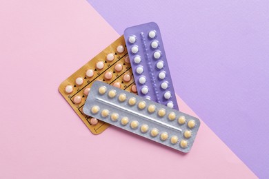 Photo of Blisters of contraceptive pills on color background, top view