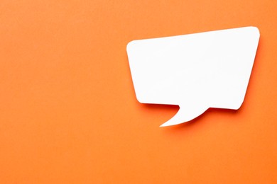 Photo of Blank speech bubble on orange background, top view. Space for text