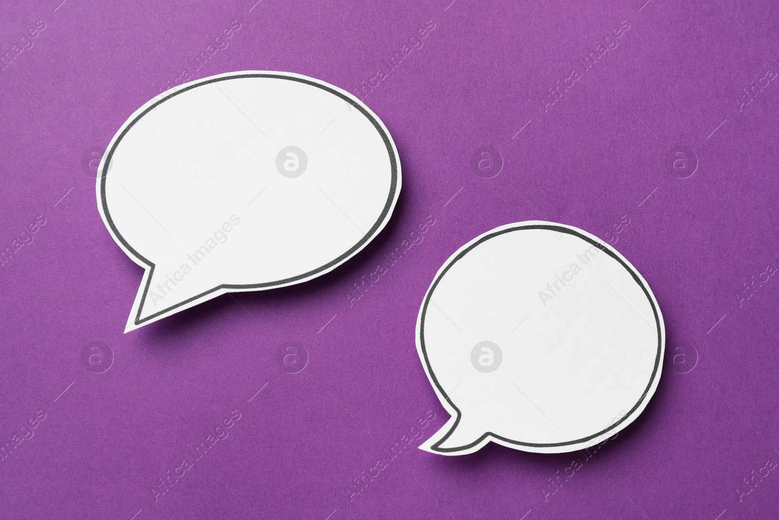 Photo of Blank speech bubbles on purple background. Space for text