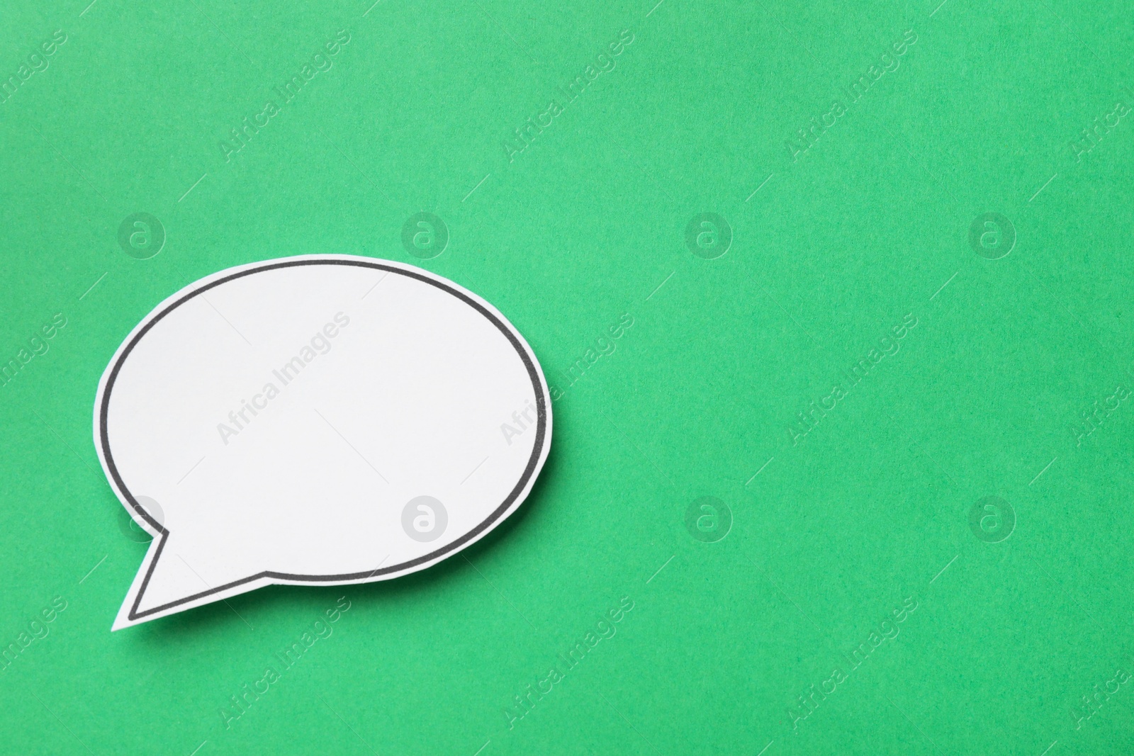 Photo of Blank speech bubble on green background. Space for text