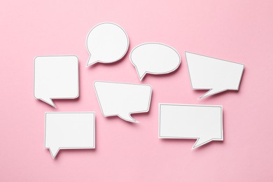 Photo of Blank speech bubbles on light pink background, top view. Space for text