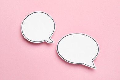 Photo of Blank speech bubbles on light pink background. Space for text