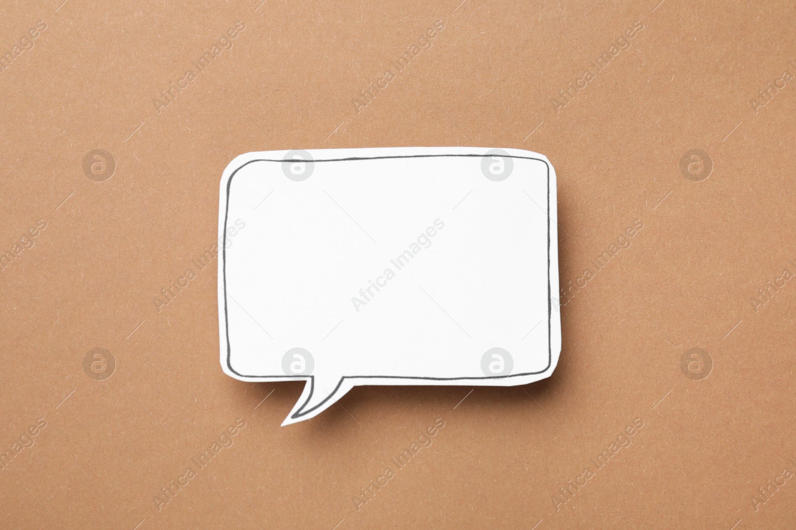 Photo of Blank speech bubble on brown background, top view. Space for text