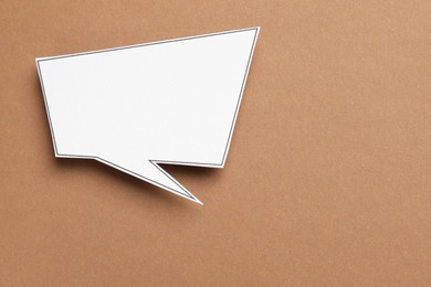 Blank speech bubble on brown background, top view. Space for text