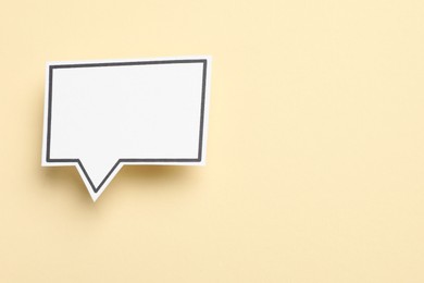 Photo of Blank speech bubble on beige background, top view. Space for text