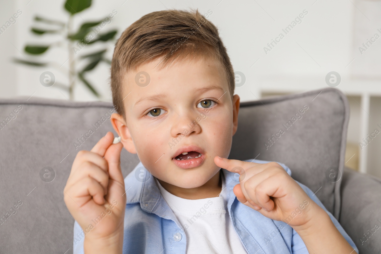 Photo of Cute little boy with missing tooth at home. Waiting for tooth fairy