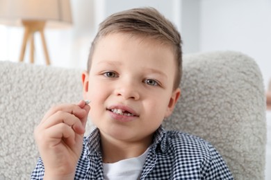 Cute little boy with missing tooth at home. Waiting for tooth fairy