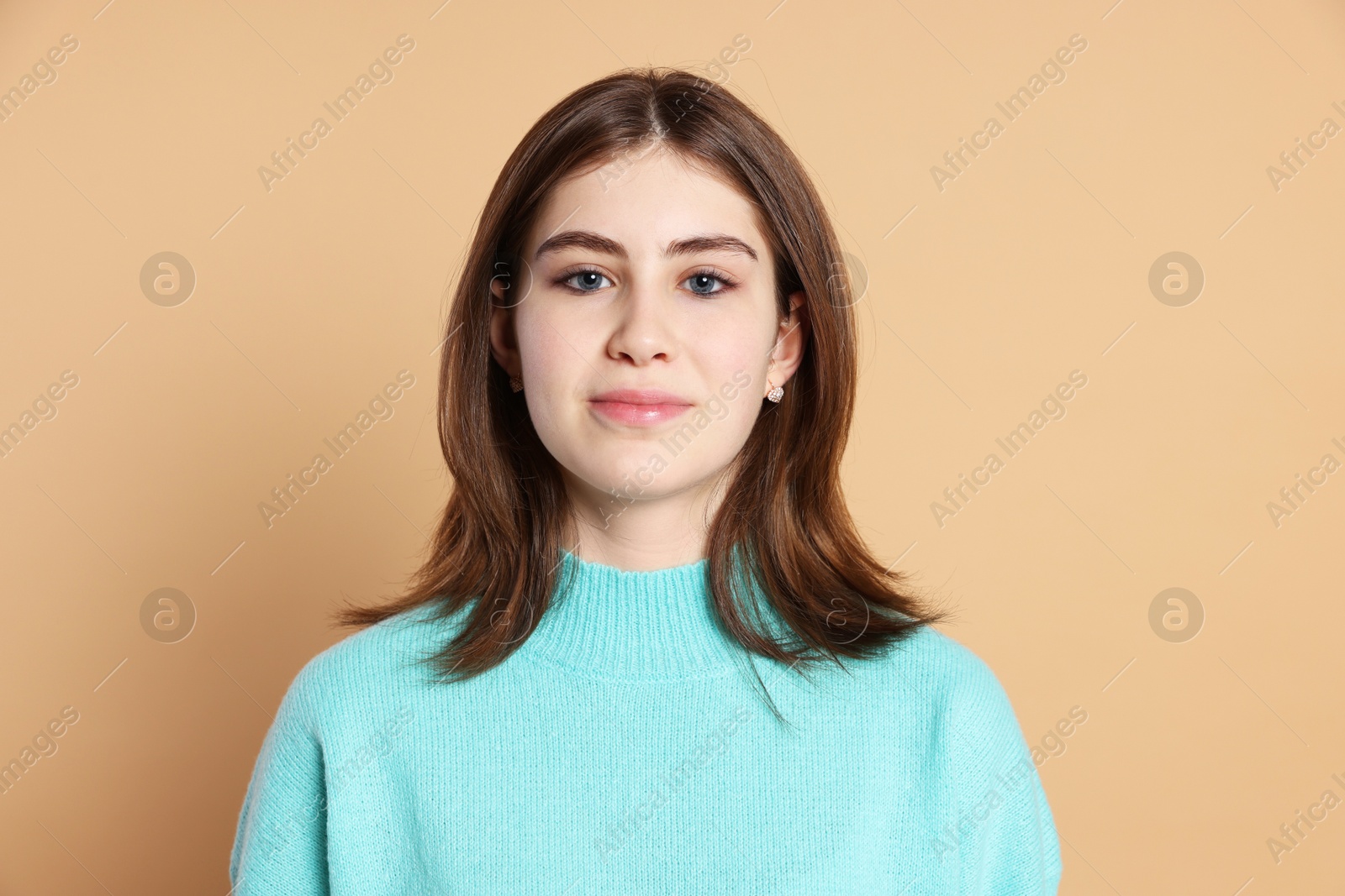 Photo of Portrait of beautiful teenage girl on beige background