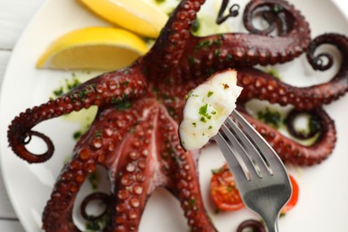 Photo of Eating tasty fried octopus with herb sauce at white table, top view