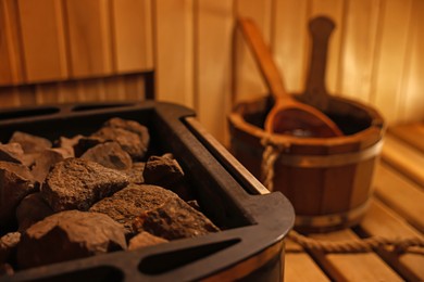 Photo of Stove with hot rocks in sauna, closeup