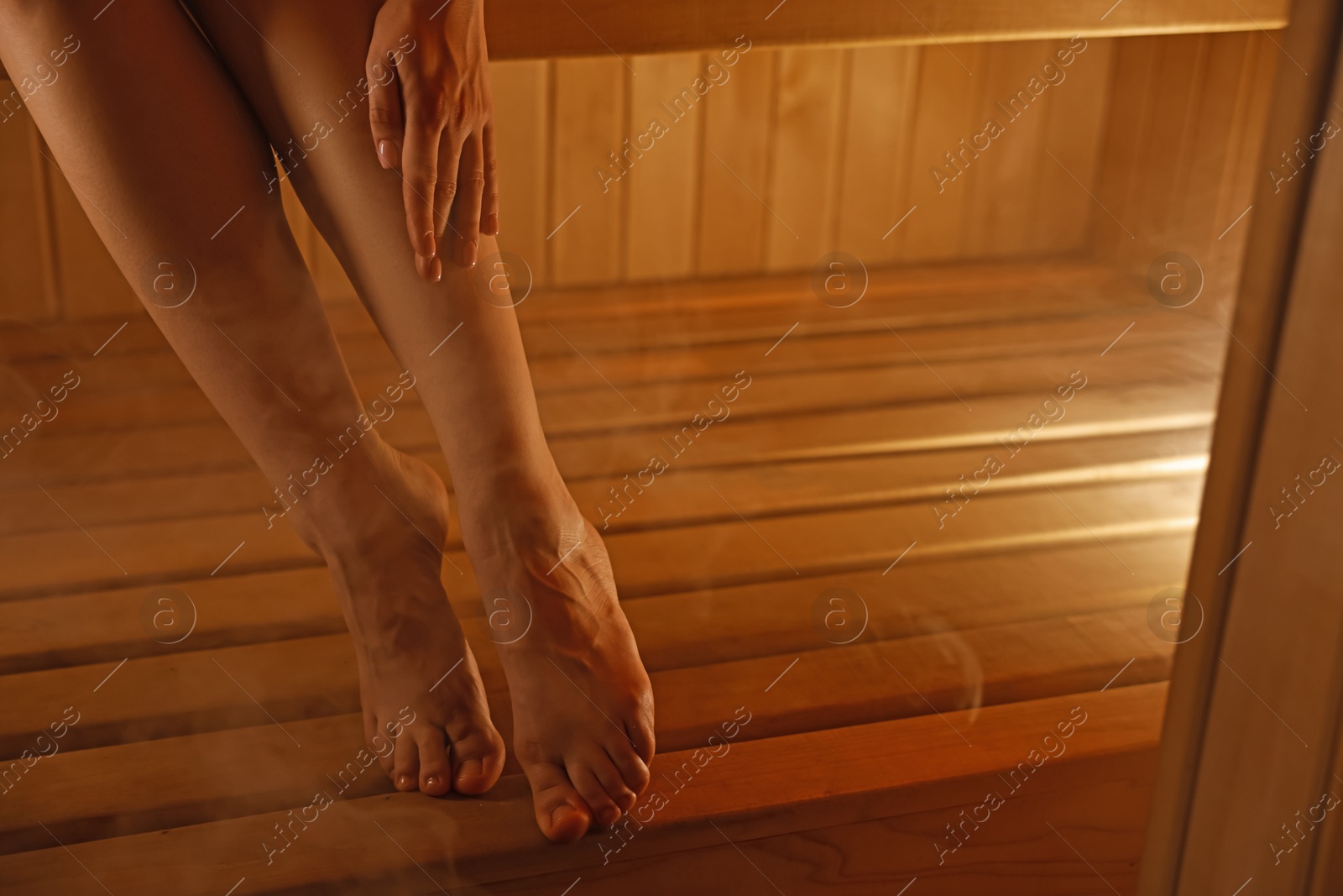 Photo of Young woman relaxing in hot sauna, closeup. Space for text