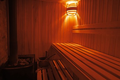 Photo of View of empty wooden sauna with bench