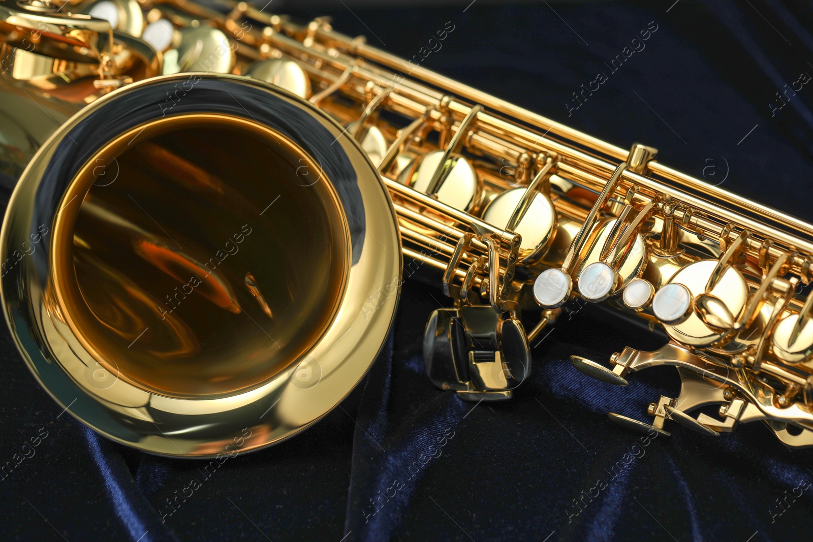 Photo of Jazz. One beautiful saxophone on black background, closeup