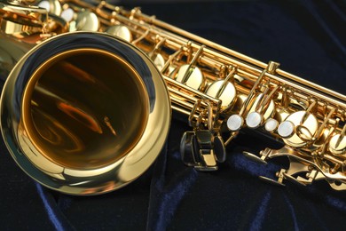 Photo of Jazz. One beautiful saxophone on black background, closeup