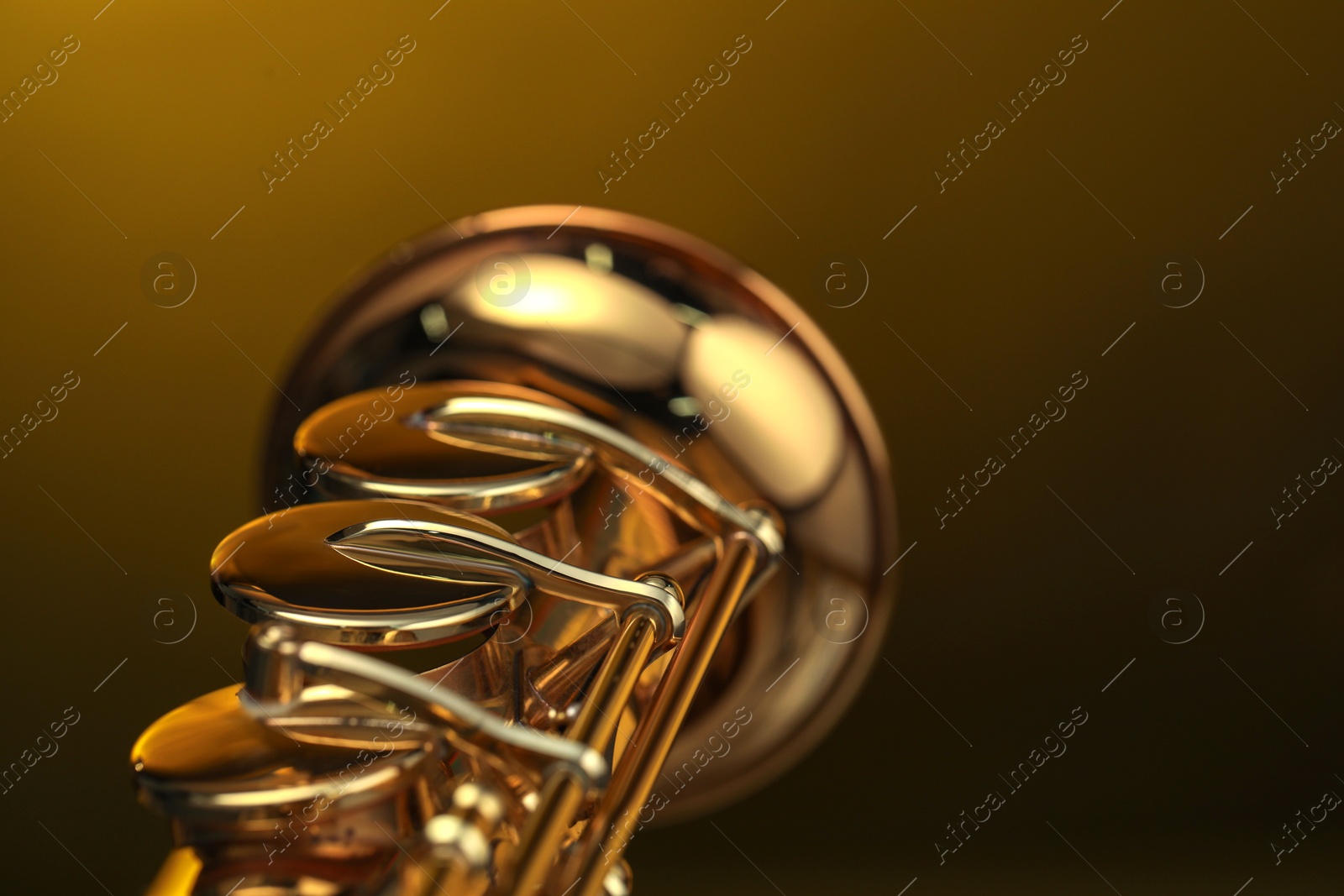 Photo of Jazz. One beautiful saxophone on color background, closeup