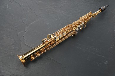 Photo of Jazz. One saxophone on black table, top view