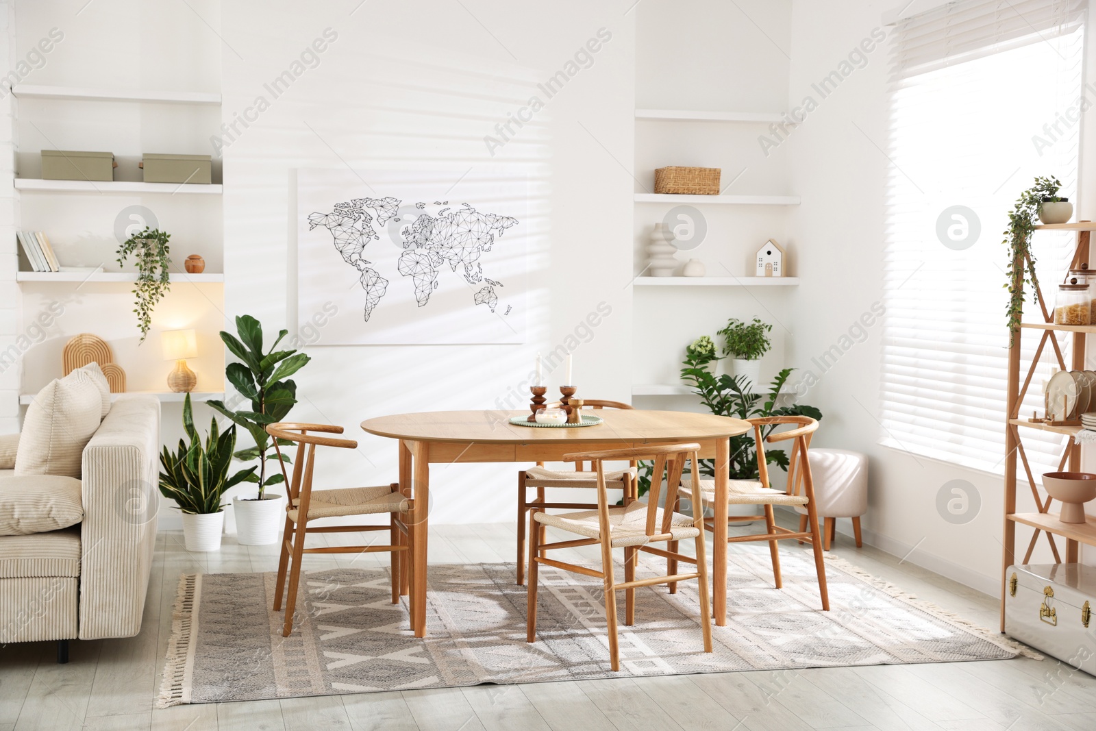 Photo of Stylish wooden table with chairs and decor indoors. Interior design