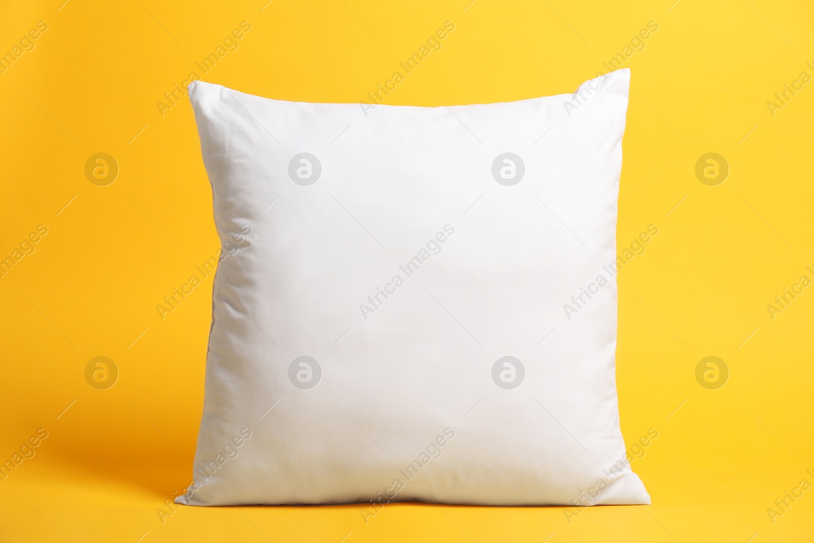 Photo of Blank pillow for branding on orange background. Mockup for design