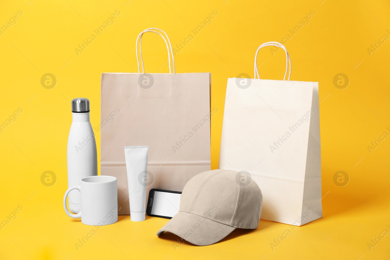 Photo of Different blank items for branding on orange background. Mockup for design