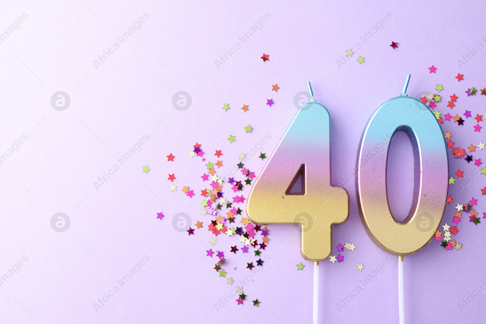 Photo of 40th birthday. Number shaped candles and confetti on violet background, flat lay. Space for text