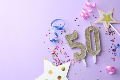 Photo of 50th birthday. Number shaped candles, confetti and party decor on violet background, flat lay. Space for text