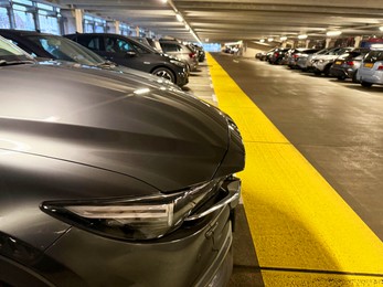 Many parked cars in underground garage of apartment complex