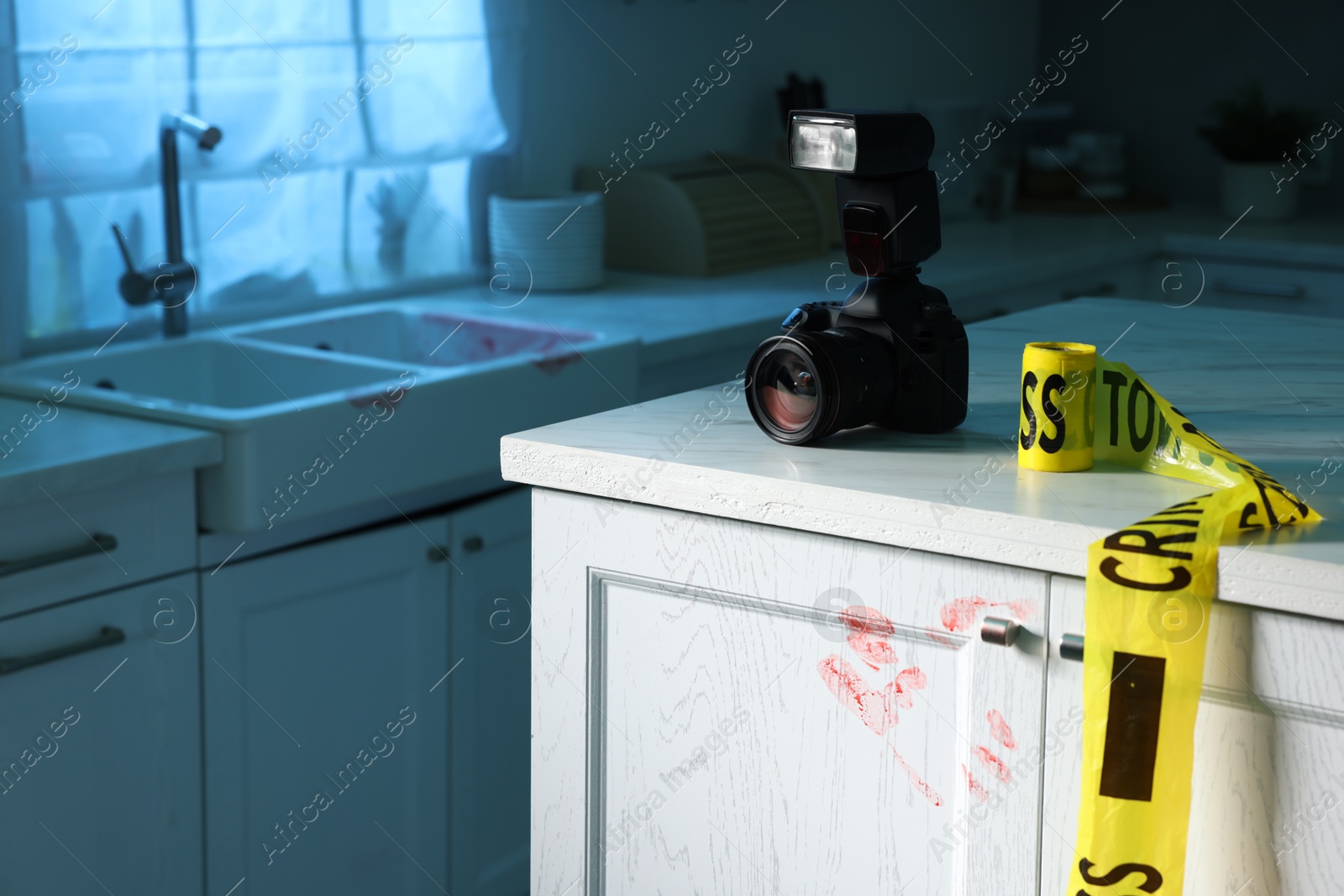 Photo of Camera, yellow crime scene tape and bloody handprint on chest of drawers in kitchen. Forensic expertise