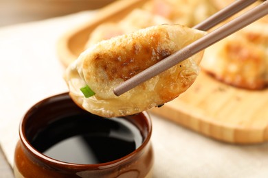 Photo of Eating fried gyoza dumplings at table, closeup