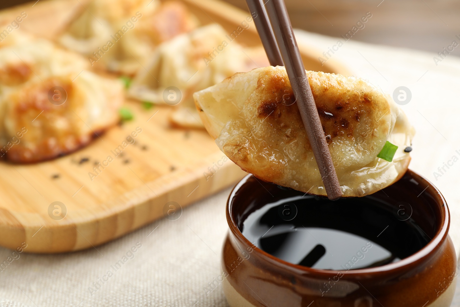 Photo of Eating fried gyoza dumplings at table, closeup