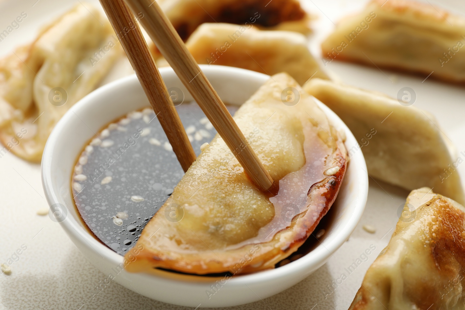 Photo of Eating fried gyoza dumplings at table, closeup