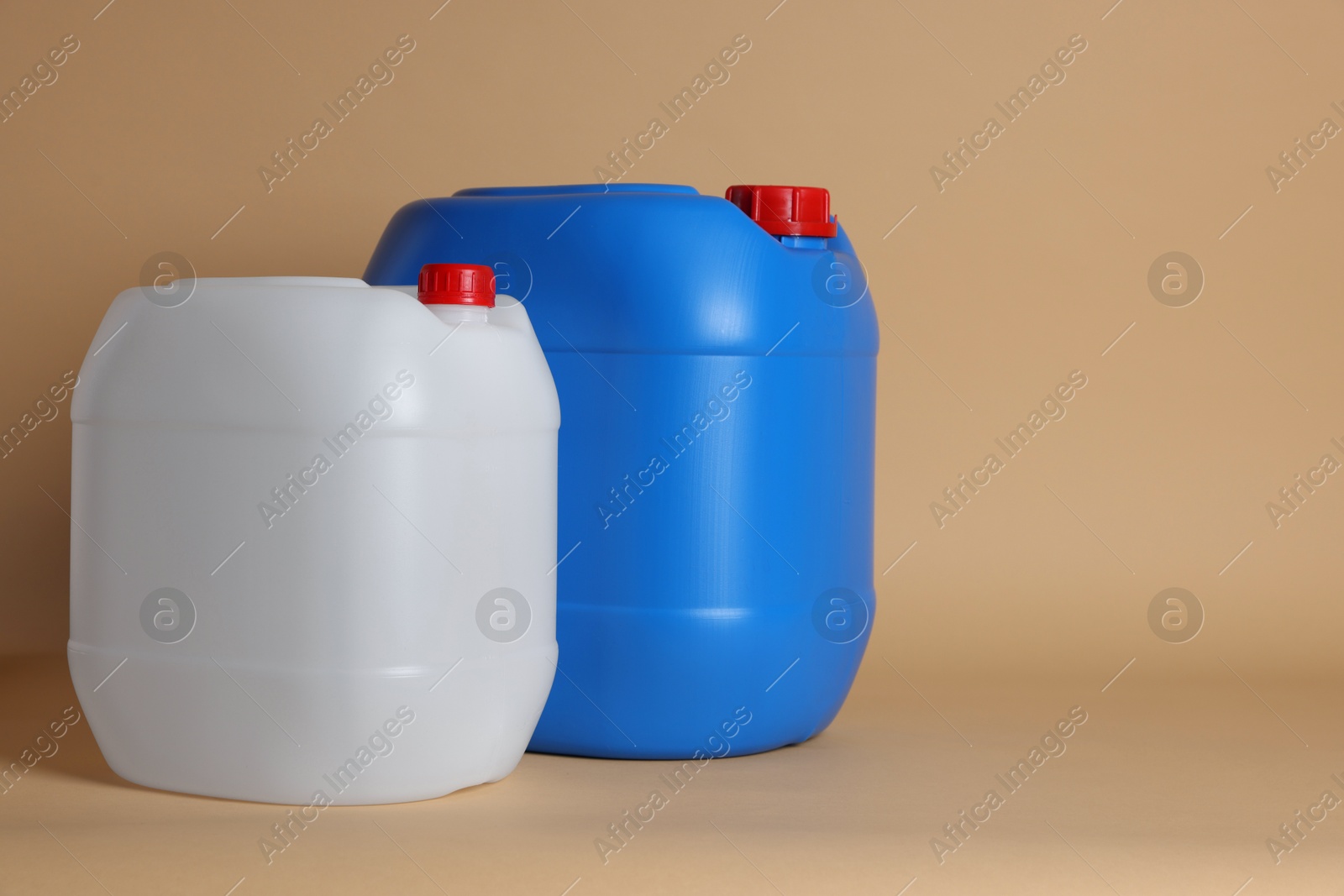 Photo of Two clean plastic canisters on beige background