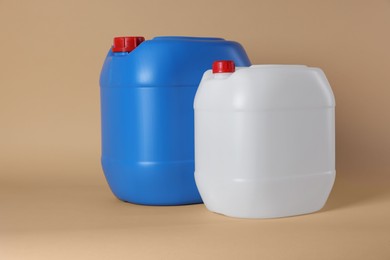 Photo of Two clean plastic canisters on beige background