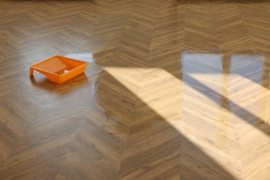 Photo of Process of polishing. Tray with varnish on floor, space for text