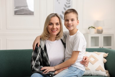 Mother and son on sofa at home