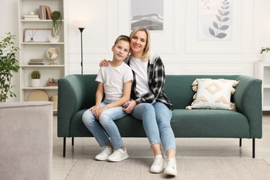 Photo of Mother and son on sofa at home