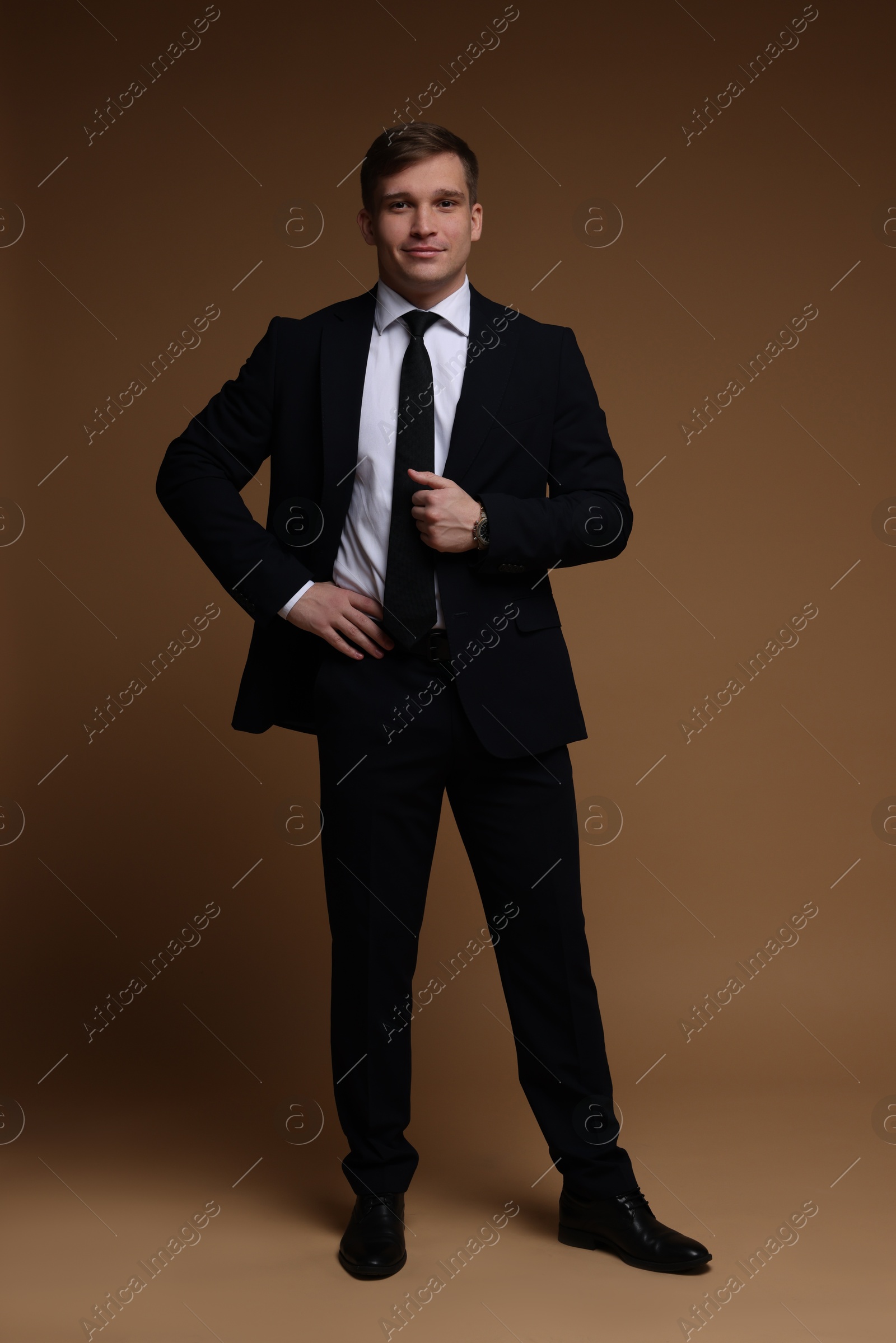 Photo of Man in classic suit on brown background