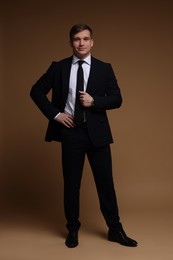 Photo of Man in classic suit on brown background