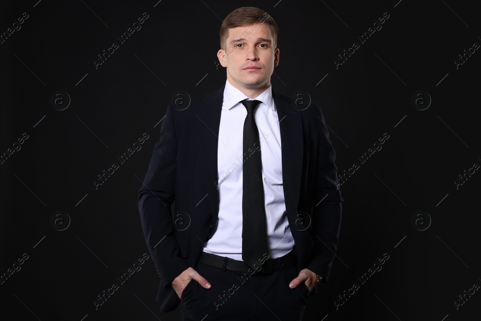 Photo of Man in classic suit on black background