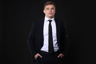 Photo of Man in classic suit on black background