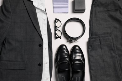 Photo of Elegant men's outfit. Stylish suit, accessories and shoes on white background, flat lay