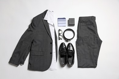 Photo of Elegant men's outfit. Stylish suit, accessories and shoes on white background, flat lay