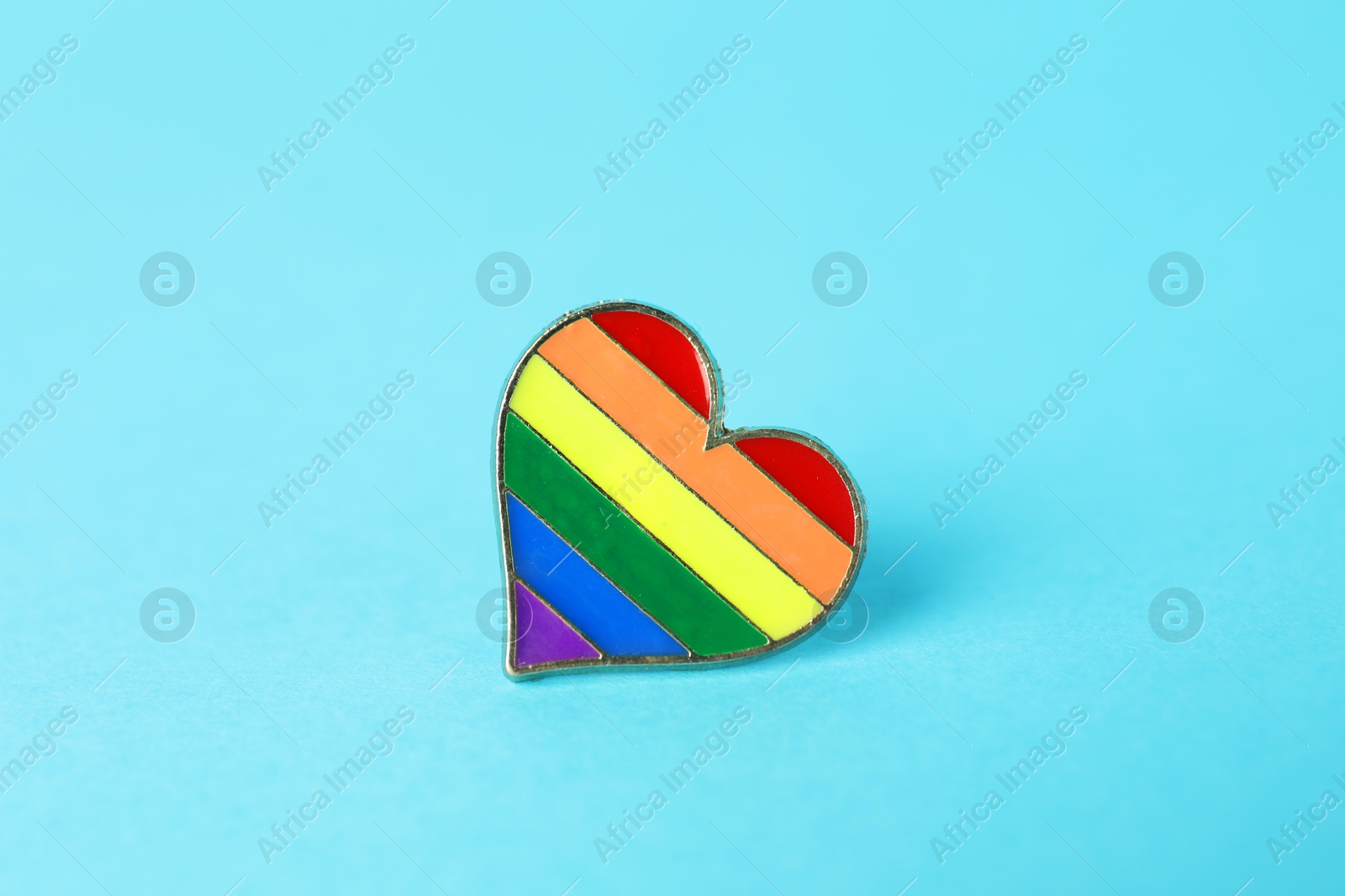 Photo of Heart shaped badge in LGBT colors on light blue background